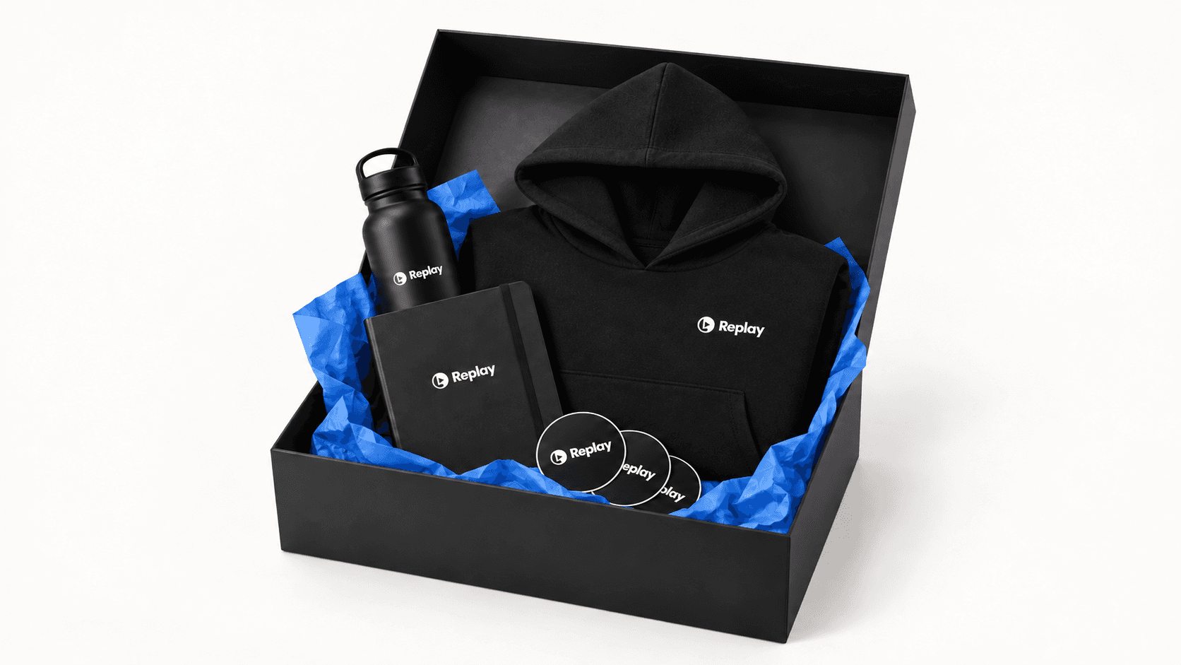 Open black Replay gift box with a Replay hoodie, water bottle, notebook, and stickers on blue tissue paper